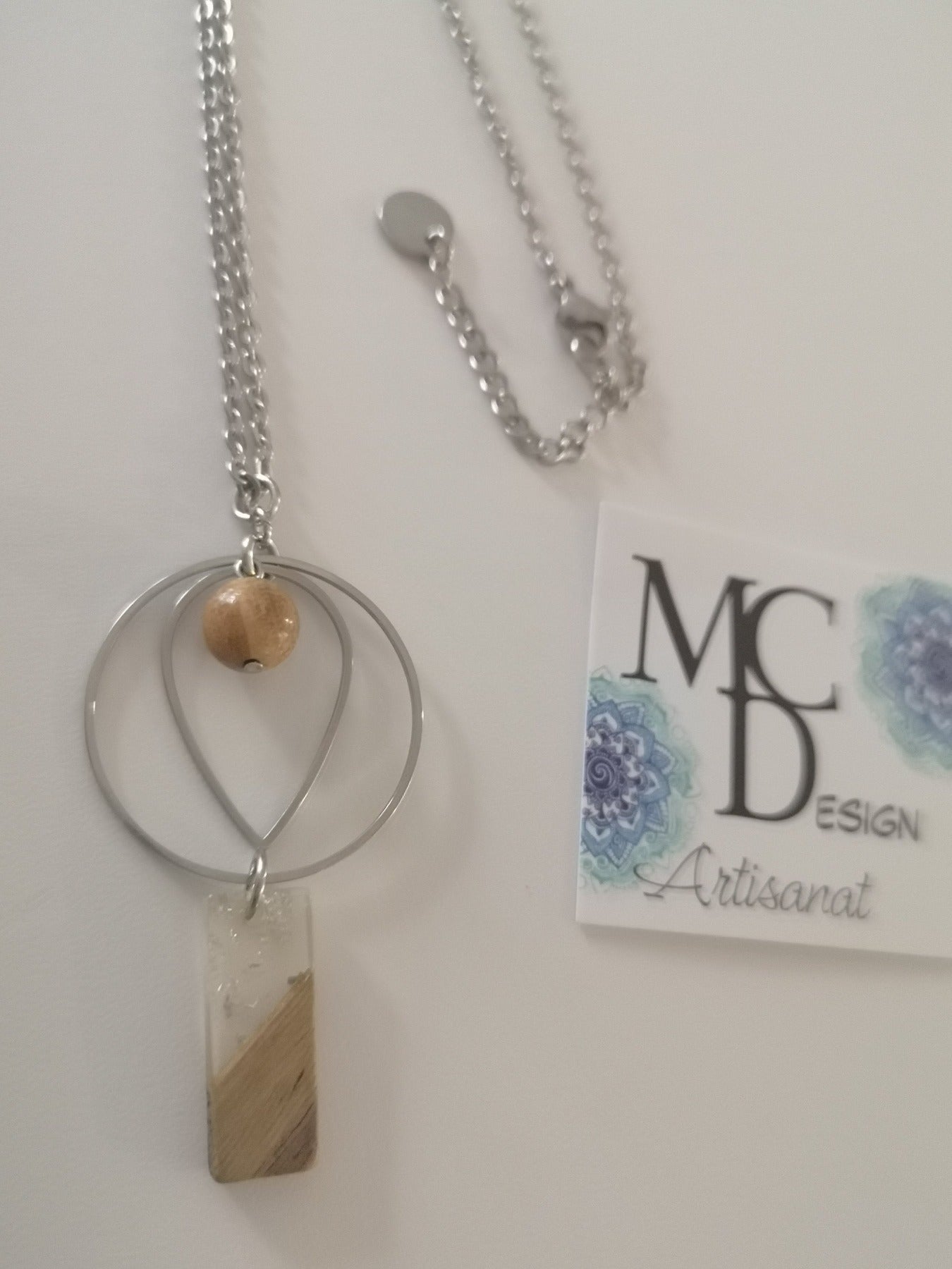 Magnifique collier long, fait avec pendentif de cercle et forme de goutte avec pierre de Jaspe Picasso er breloque carré en bois et résine. Collier très versatile et se porte avec beaucoup de style.